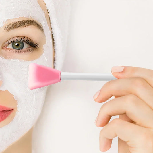 Close-up of the spoon end scooping skincare product