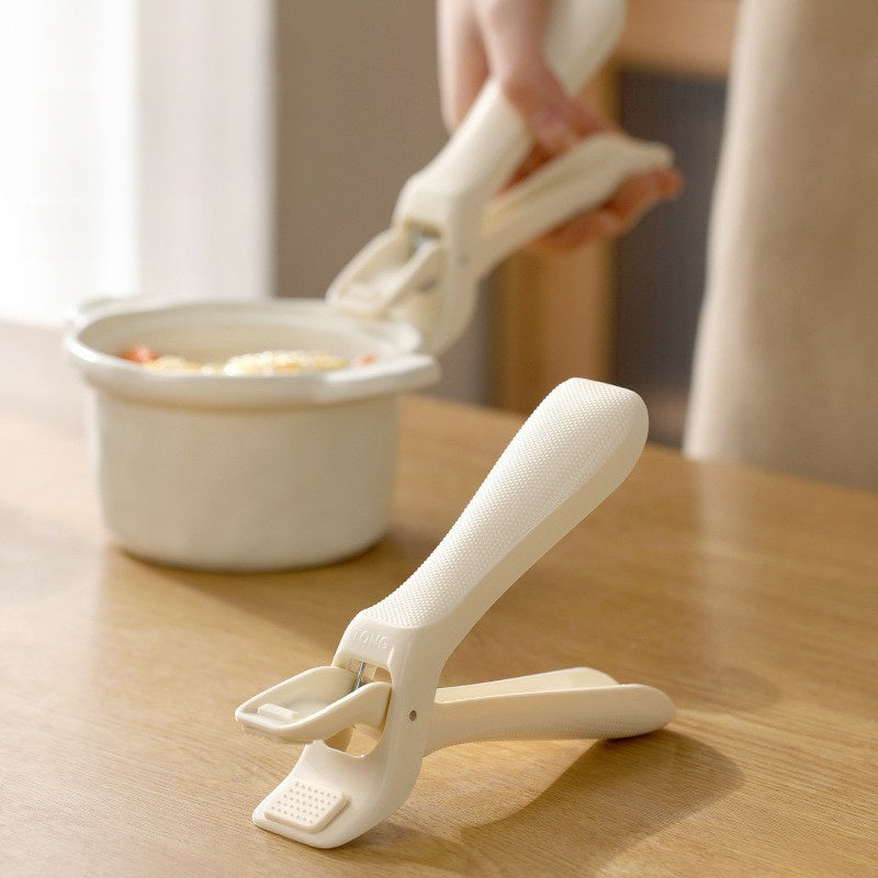 Anti-scald bowl gripper lifting a hot ceramic bowl White